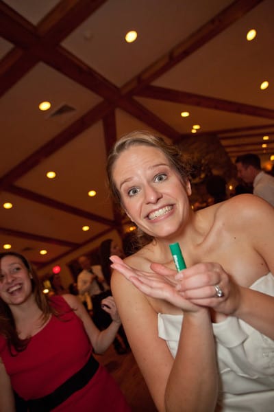 Chrissy Carroll at a wedding holding a chapstick.