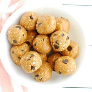 A white bowl filled with healthy peanut butter cookie dough bites.