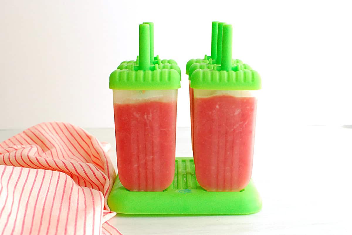 Strawberry peach popsicles in a popsicle mold.