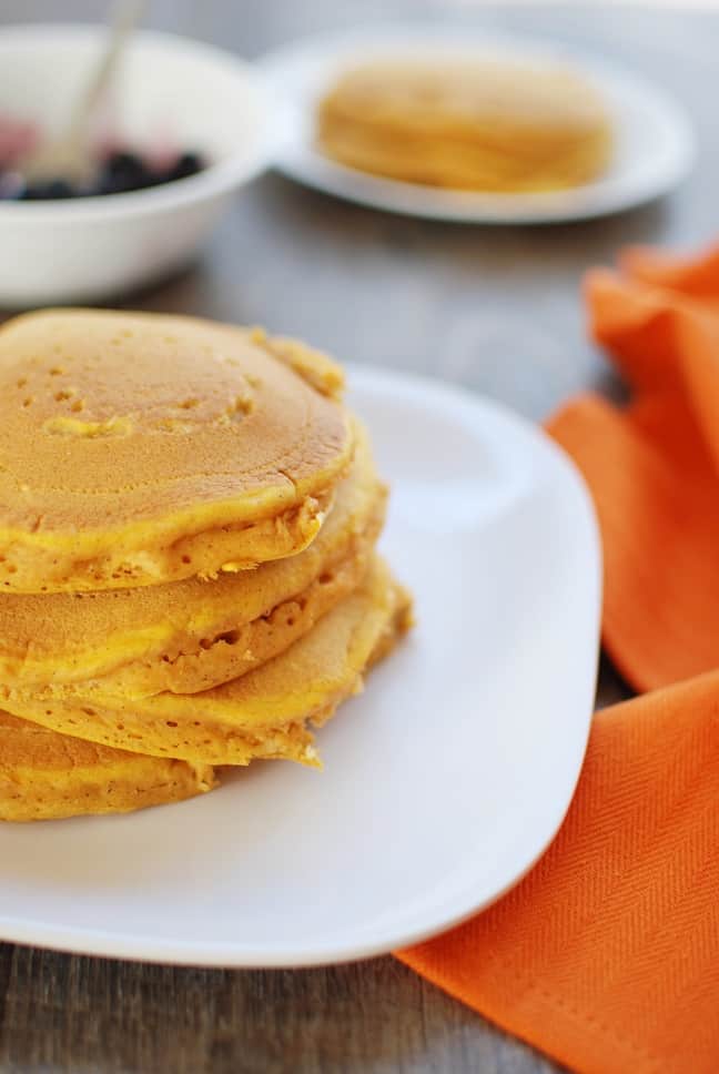 These healthy whole wheat pumpkin pancakes are light and fluffy - a favorite fall breakfast recipe for kids and adults alike!