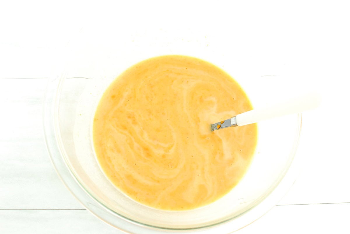 All the wet ingredients stirred together in a glass bowl.