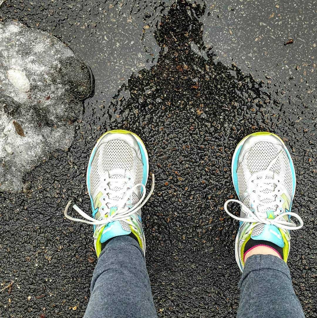 A runner's sneakers on the pavement.