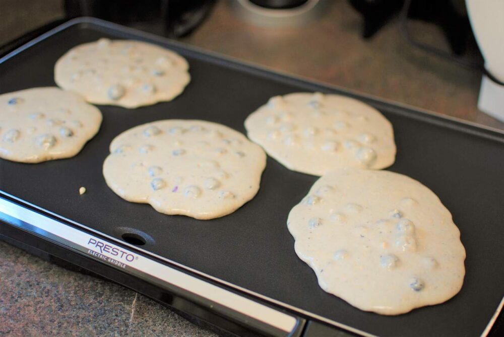 Blueberry yogurt pancakes on the griddle