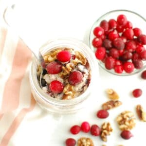 A mason jar filled with cranberry walnut overnight oats.