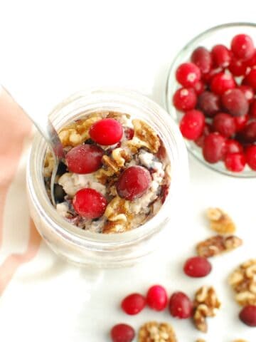 A mason jar filled with cranberry walnut overnight oats.