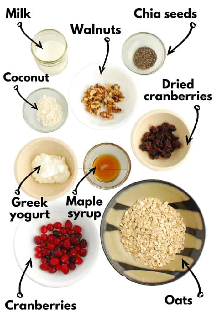Oats, cranberries, yogurt, maple syrup, walnuts, coconut, milk, and chia seeds.