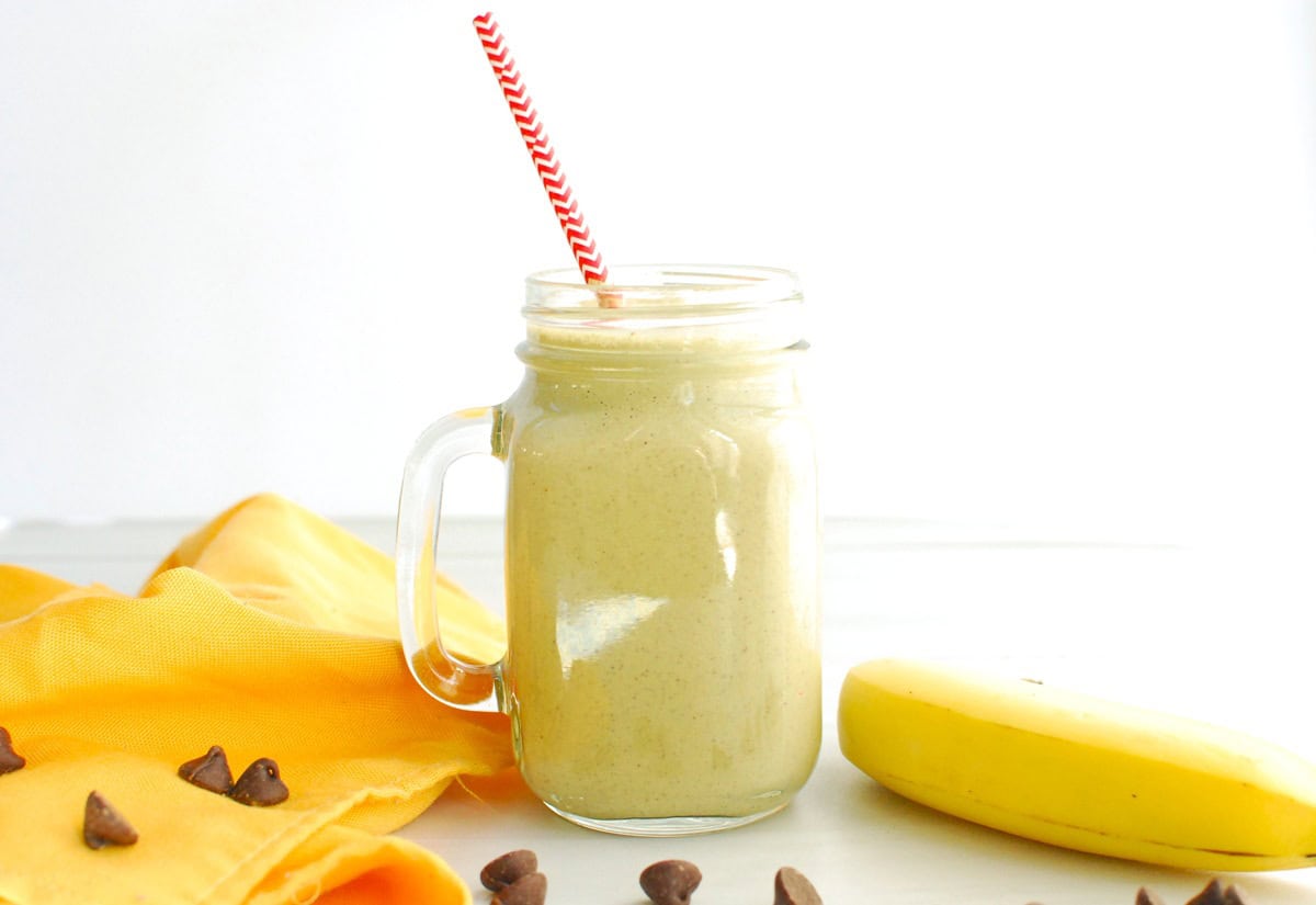A post workout banana peanut butter chocolate smoothie in a glass jar.