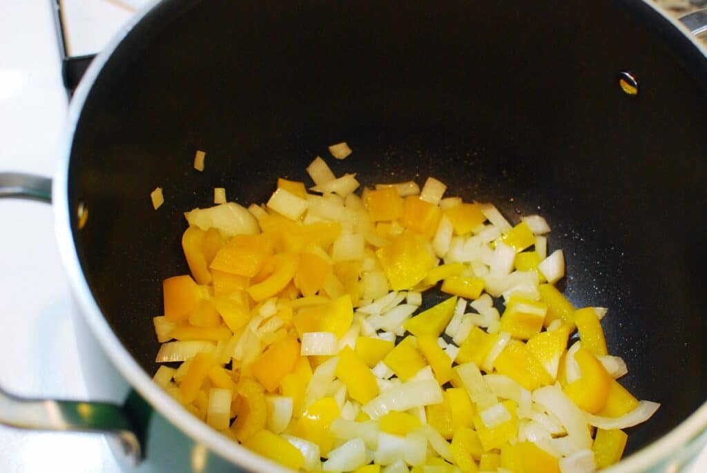 Peppers and onions in a pot.