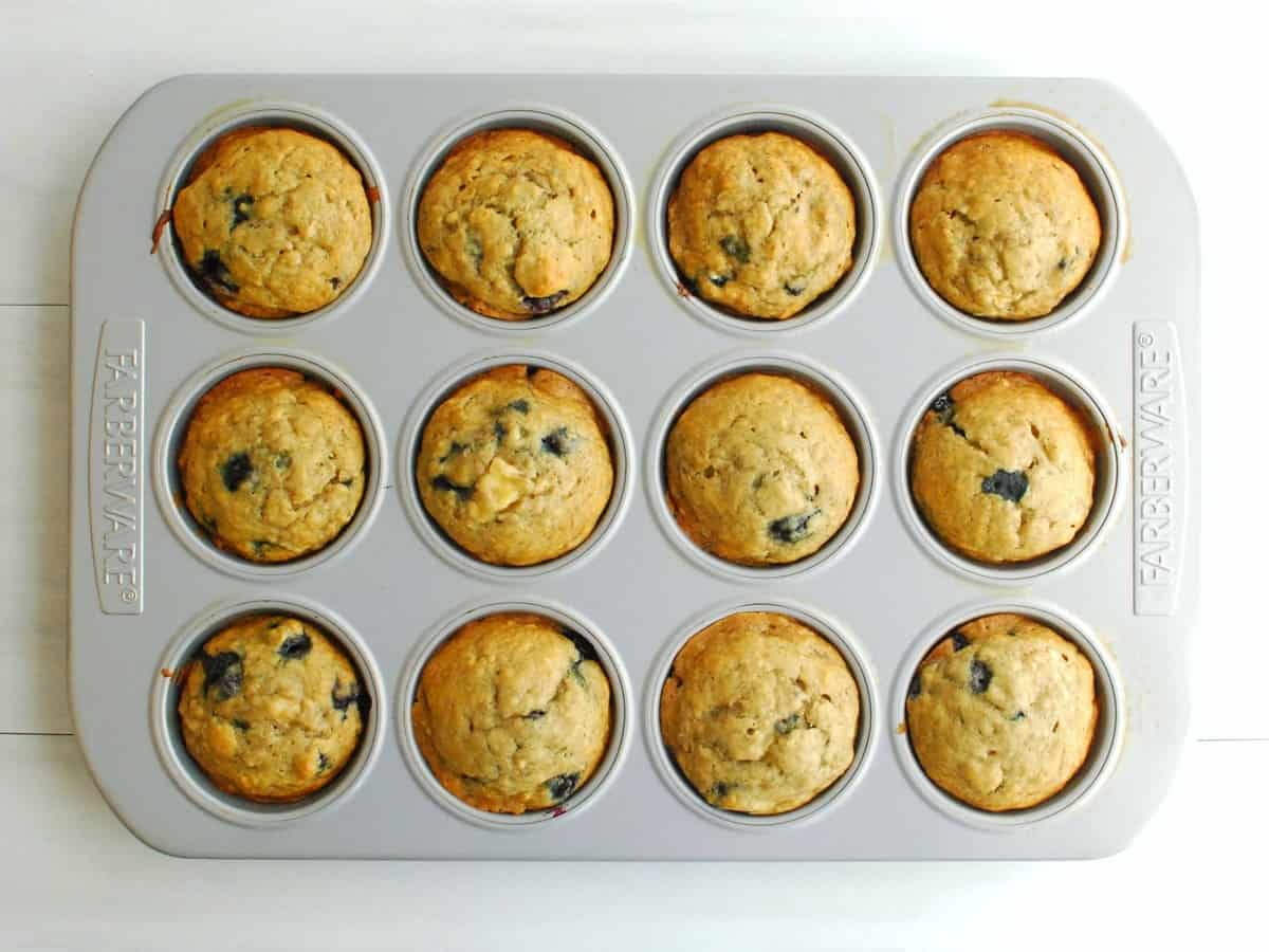 A muffin tin full of just-baked muffins.