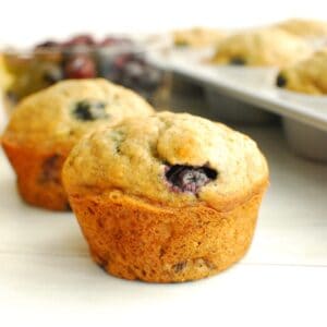 A close up of a whole wheat banana blueberry muffin.