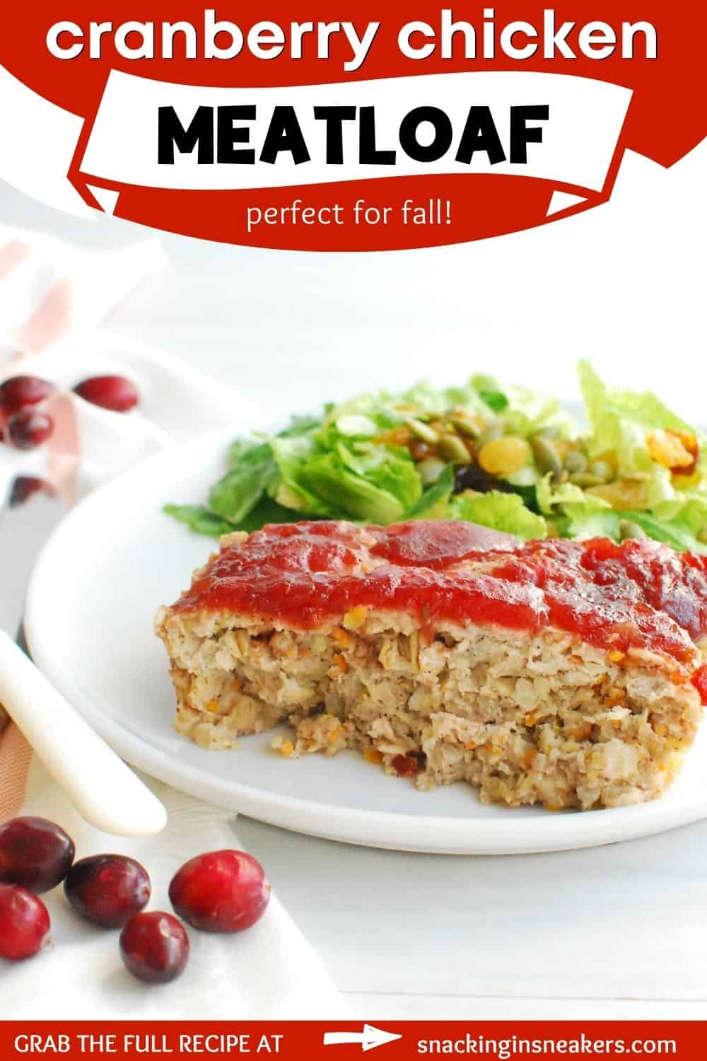 A slice of cranberry chicken meatloaf with salad on a plate, with a text overlay for Pinterest.
