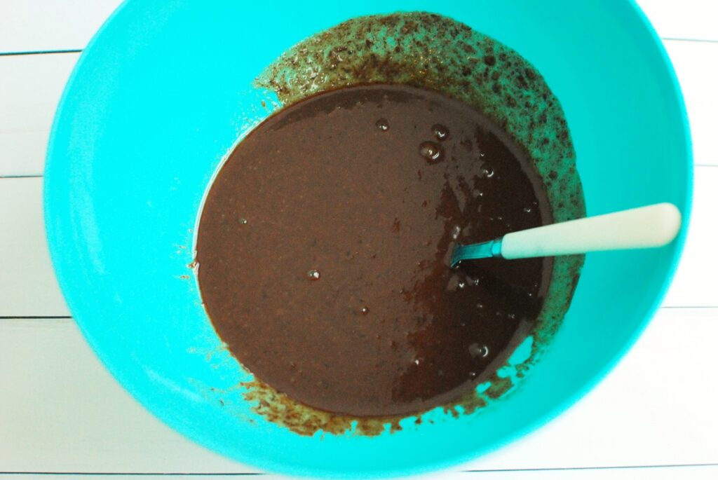 A bowl with the brownie batter after adding the melted dark chocolate.