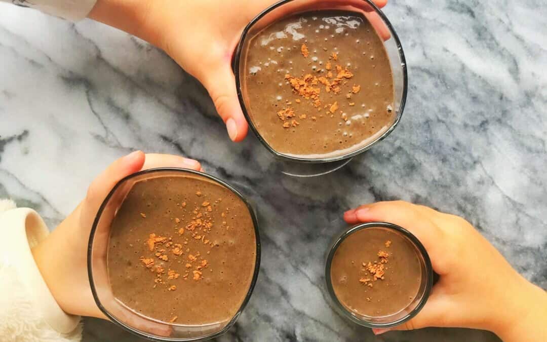 A chocolate cherry smoothie in a glass.