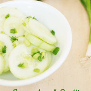 Low carb cucumber salad next to scallions and cucumbers