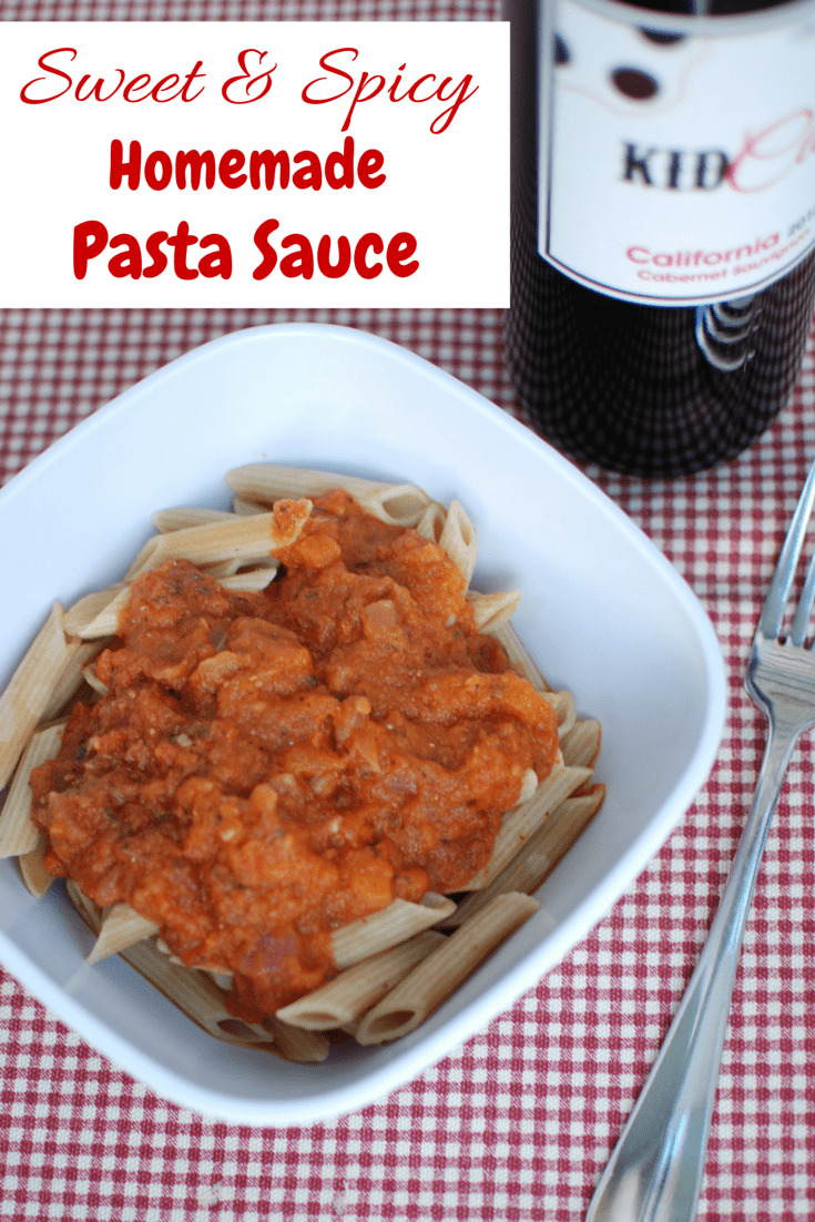 A bowl of pasta topped with vegetarian spaghetti sauce, next to a fork