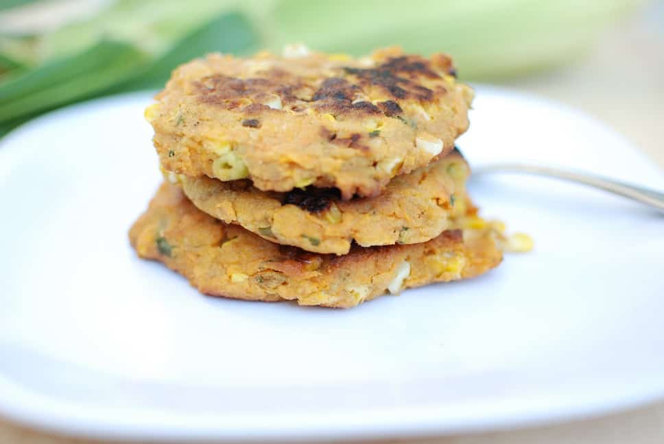 Close up of 3 vegan corn fritters on a plate