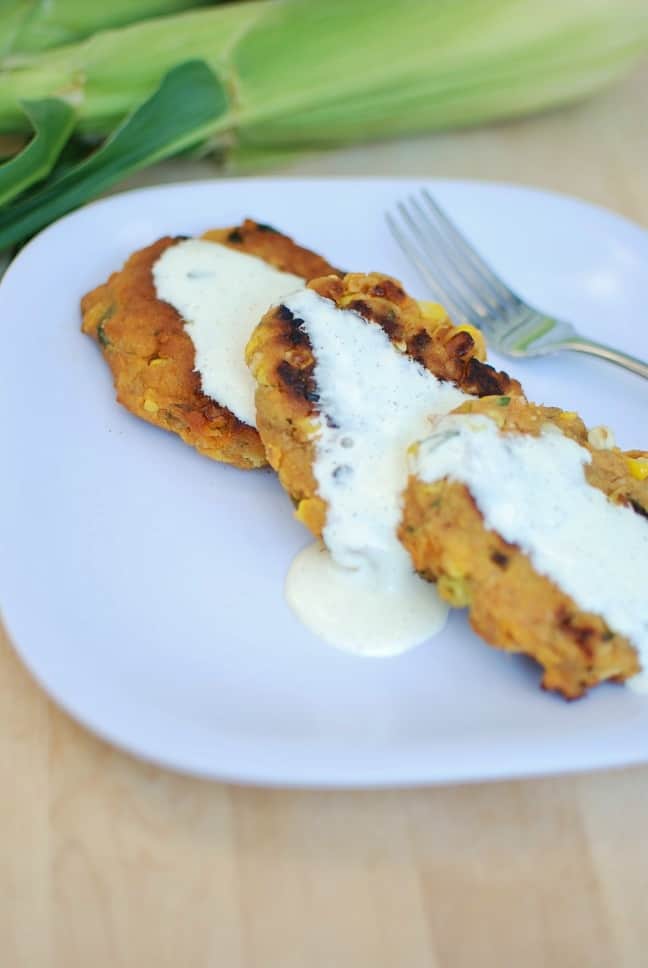 Corn and Sweet Potato Fritters with aquafaba ailoi on a plate