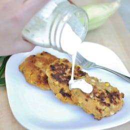 Vegan corn fritters with aquafaba aioli being poured on top