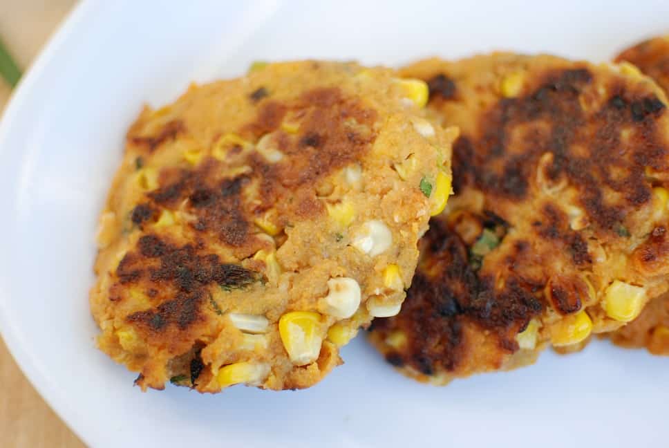 Vegan corn fritters on a white plate