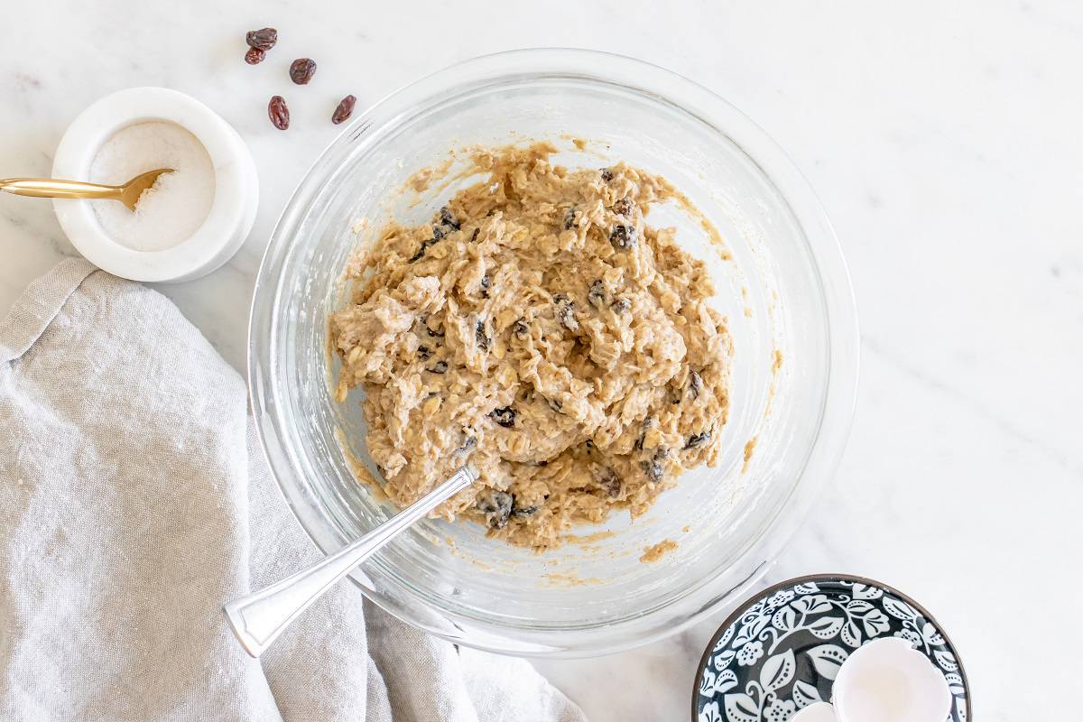 A glass mixing bowl with cookie dough.