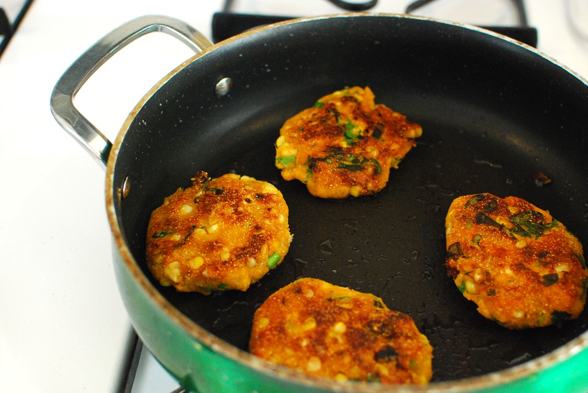Fritters being cooked in a skillet.