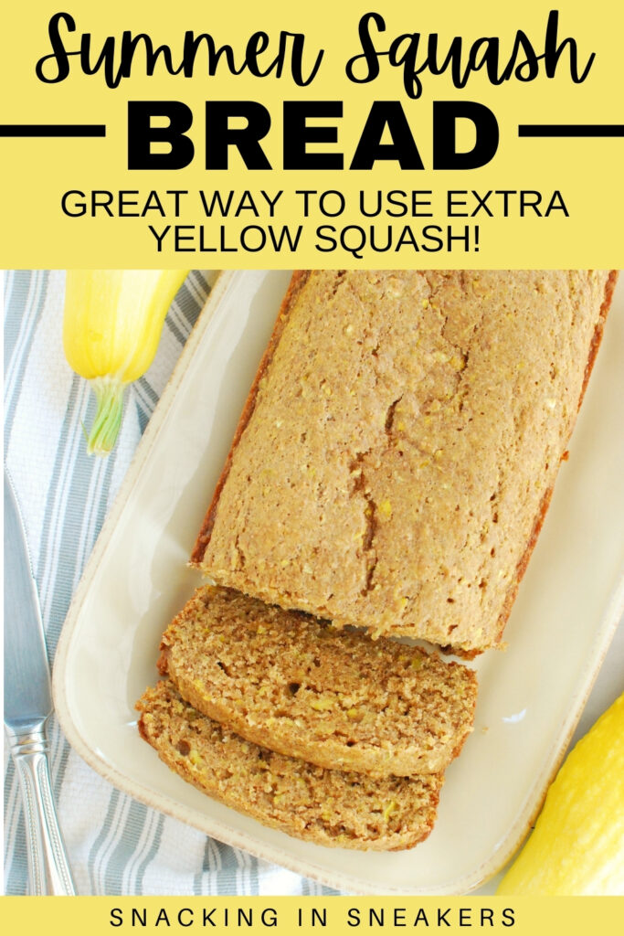 A loaf of summer squash bread with two slices cut into it, next to some fresh yellow squash.