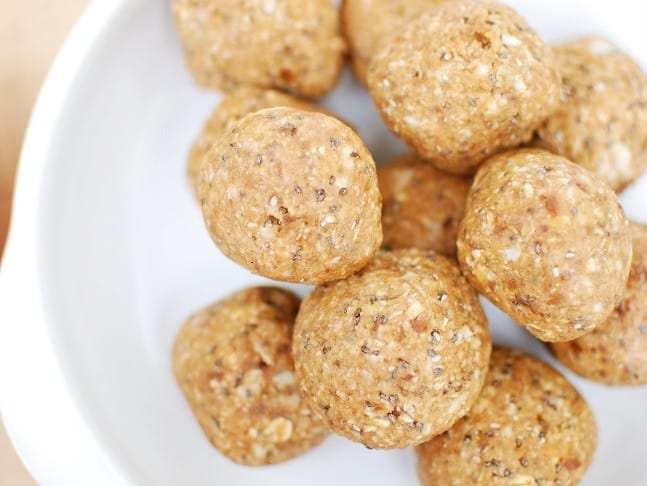 A white plate with apple peanut butter energy bites for a healthy apple snack.