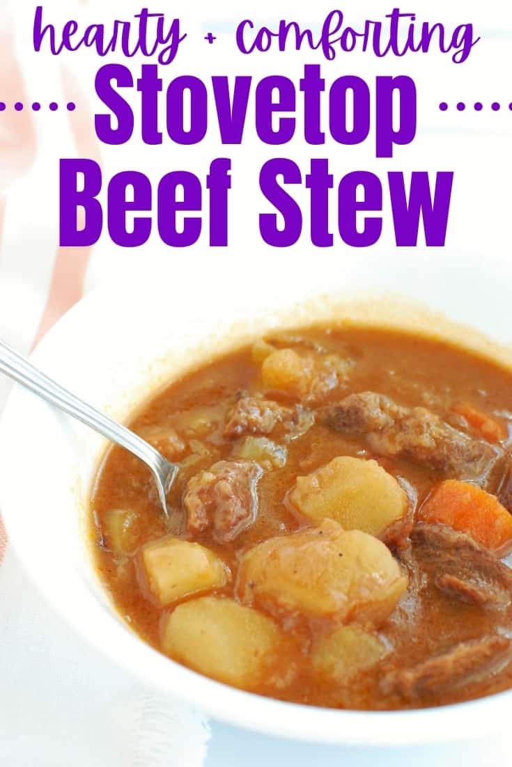 A white bowl with a spoon in it full of stovetop beef stew.