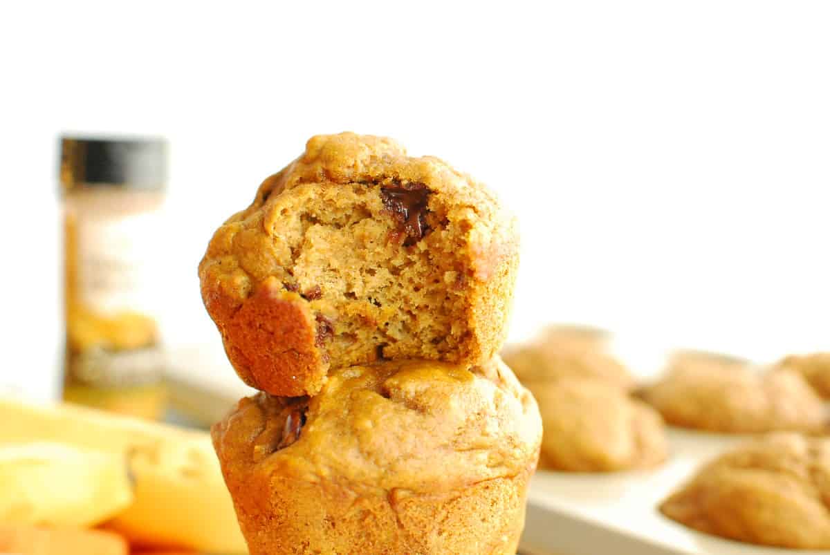 A pumpkin muffin with a bite taken out of it.