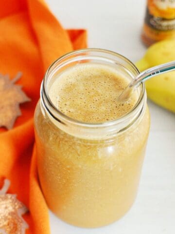 A pumpkin coffee smoothie in a mason jar.