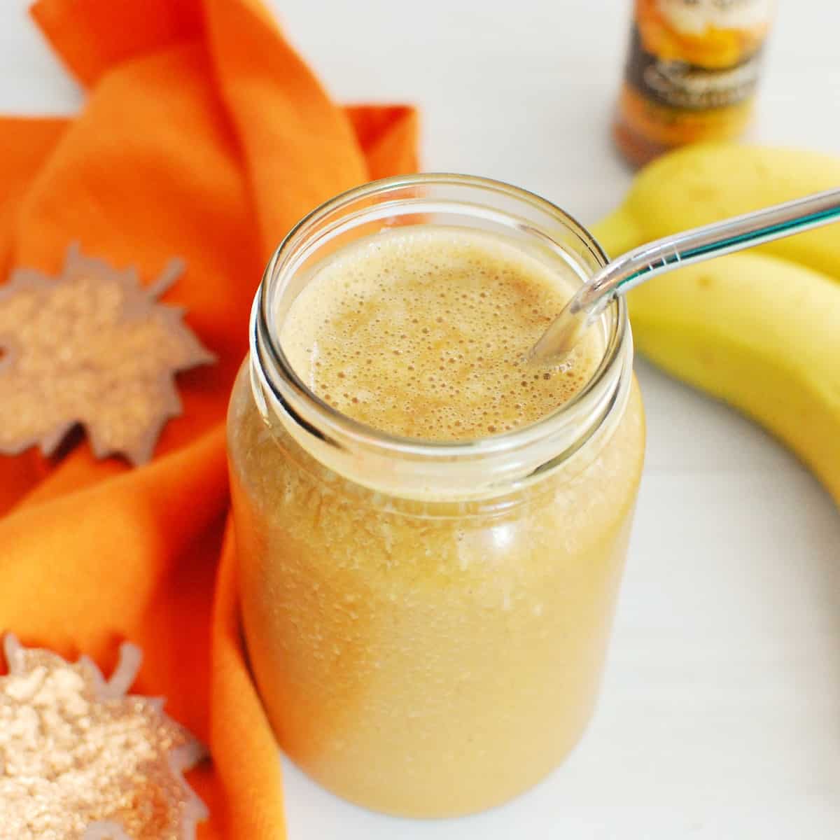 A pumpkin coffee smoothie in a mason jar.