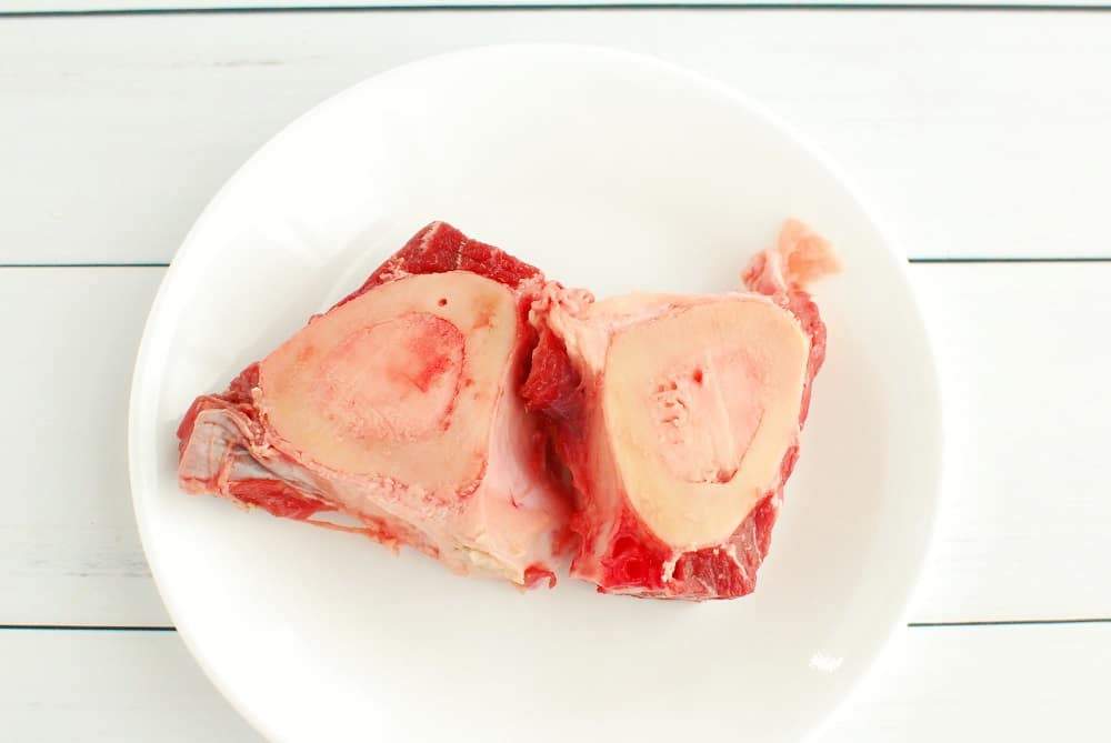 Beef shank bones on a small white plate.