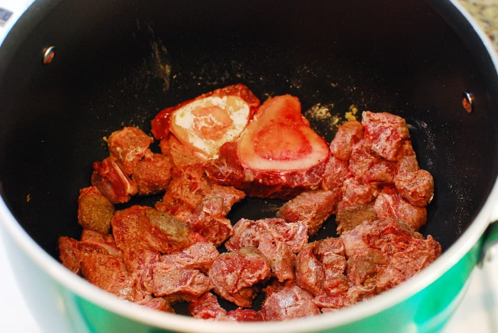 Beef browning in a pot.