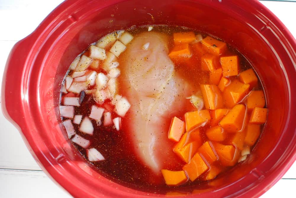 A crockpot with all the soup ingredients added.