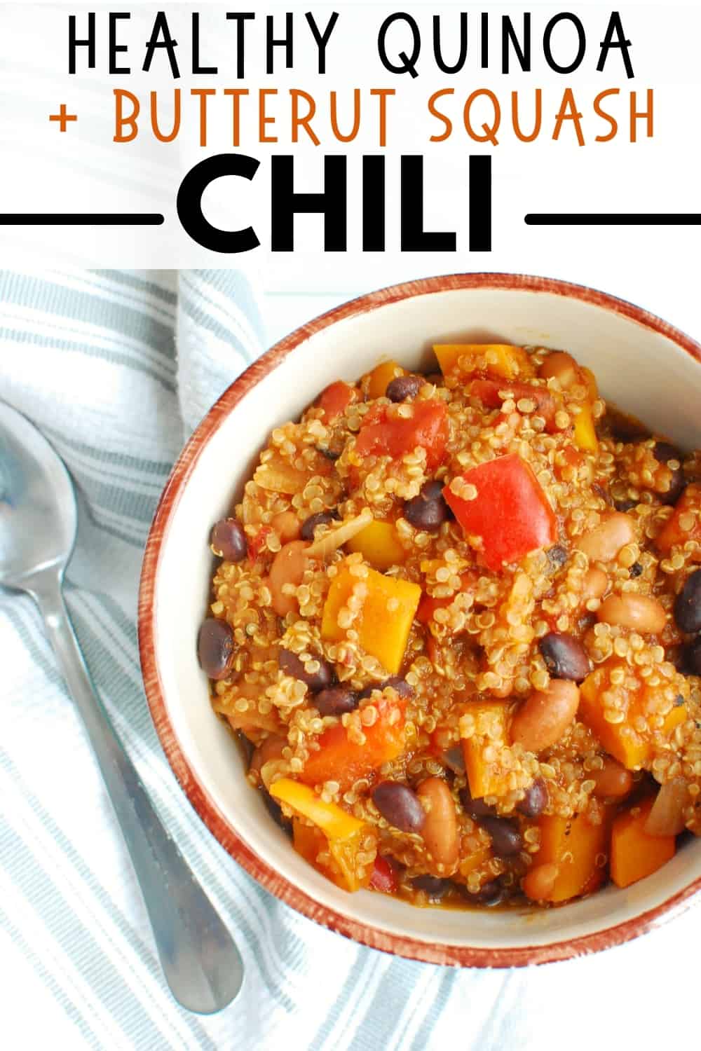 A bowl full of butternut squash quinoa chili with a spoon next to it.