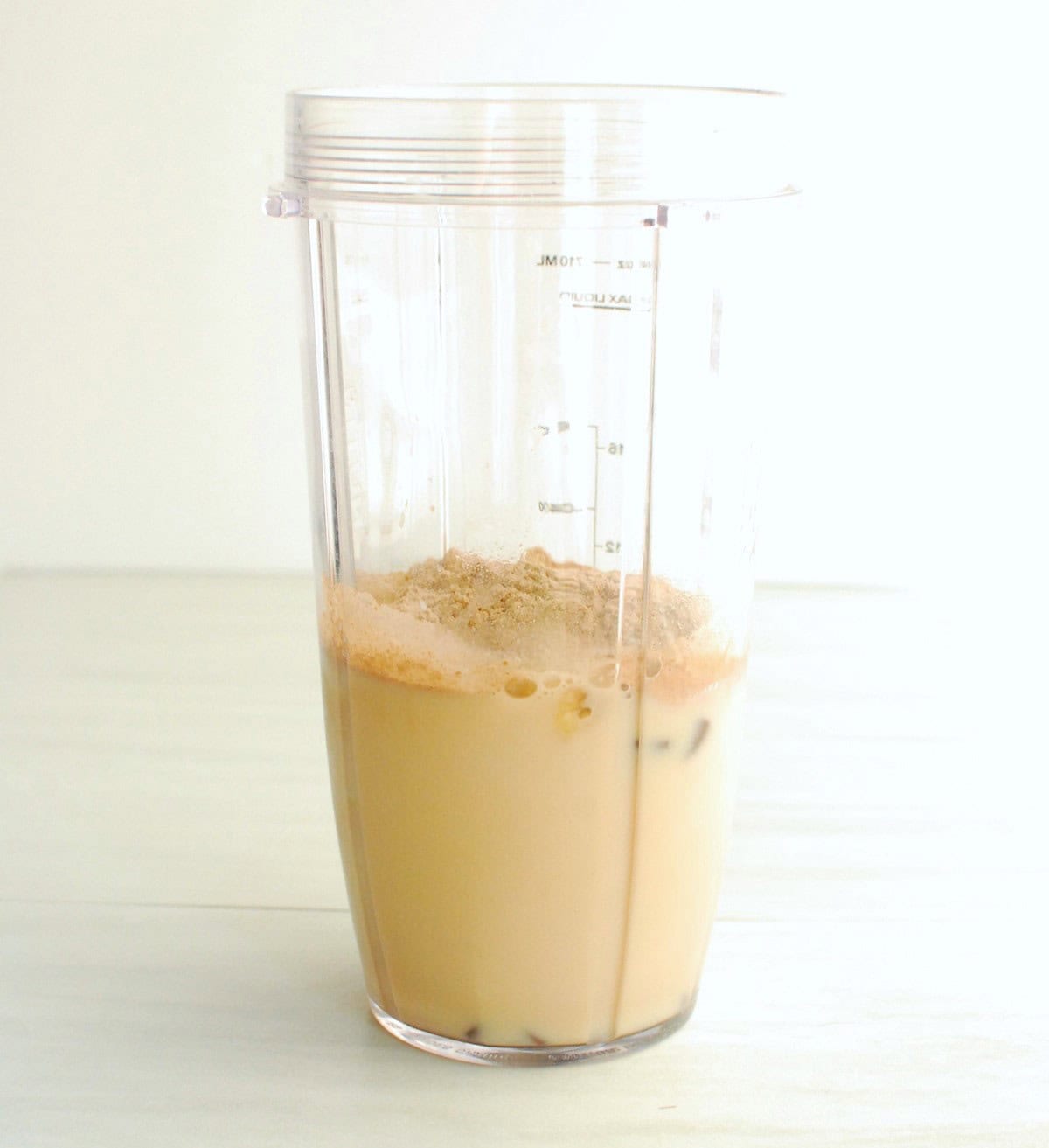 All of the smoothie ingredients in a blender cup.