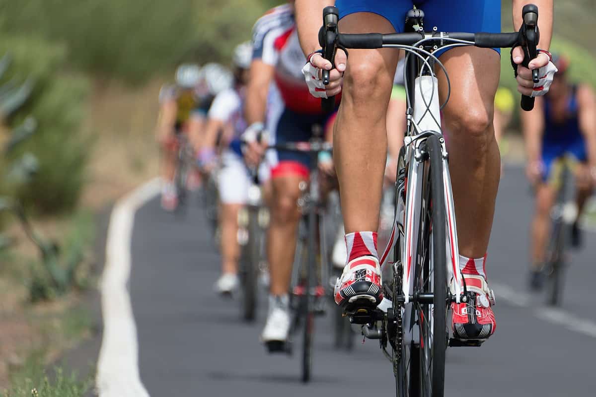 A group of cyclists riding on the road.