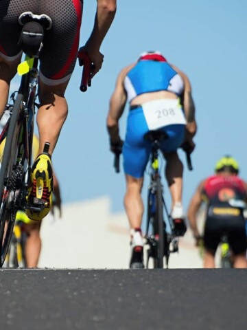 Cyclists on the road during a triathlon race.