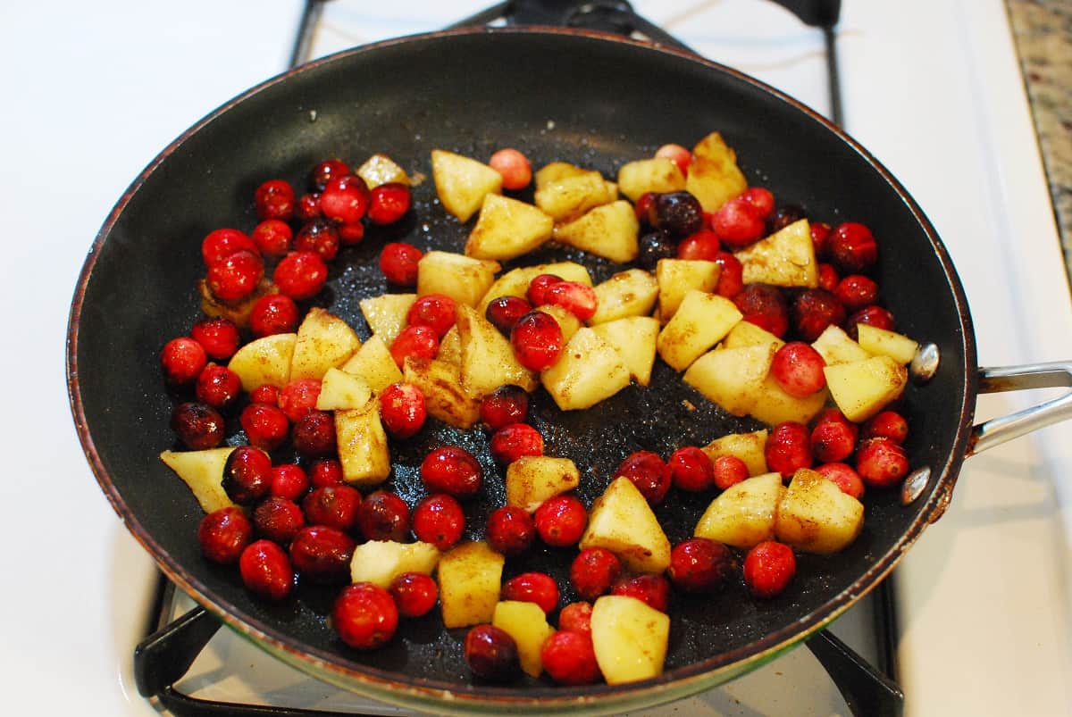 Cranberries, apples, and brown sugar in a skillet.