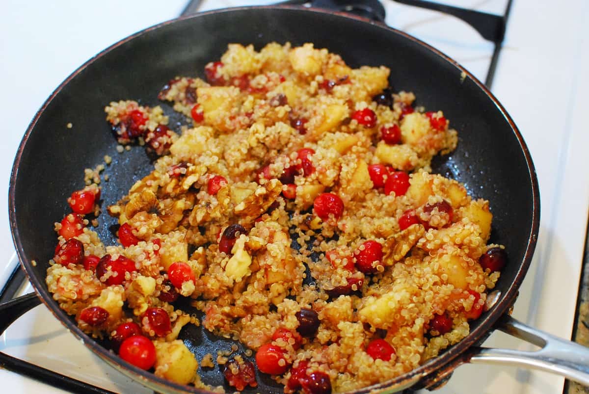 A skillet with a cranberry apple breakfast quinoa.
