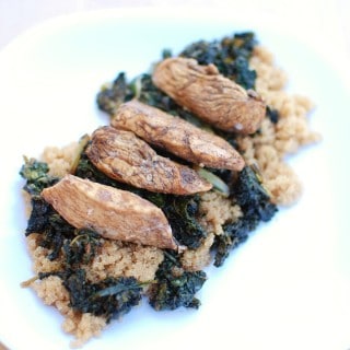 A white plate filled with honey balsamic chicken, kale, and amaranth.