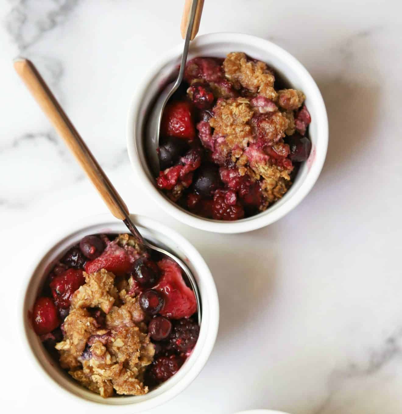 Two ramekins with healthy mixed berry crisp.