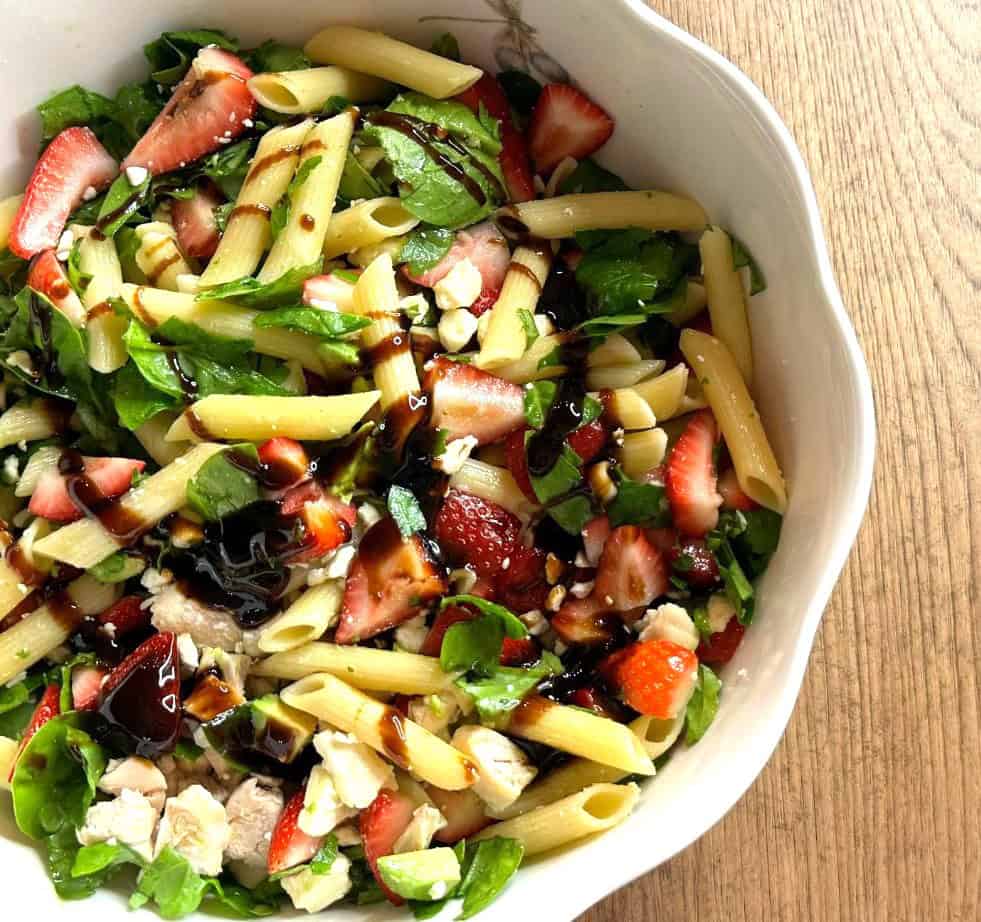 A bowl of strawberry pasta salad.