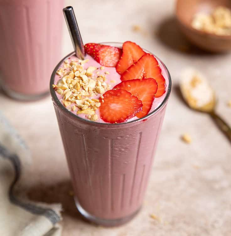 Vegan peanut butter banana strawberry smoothie in a glass.
