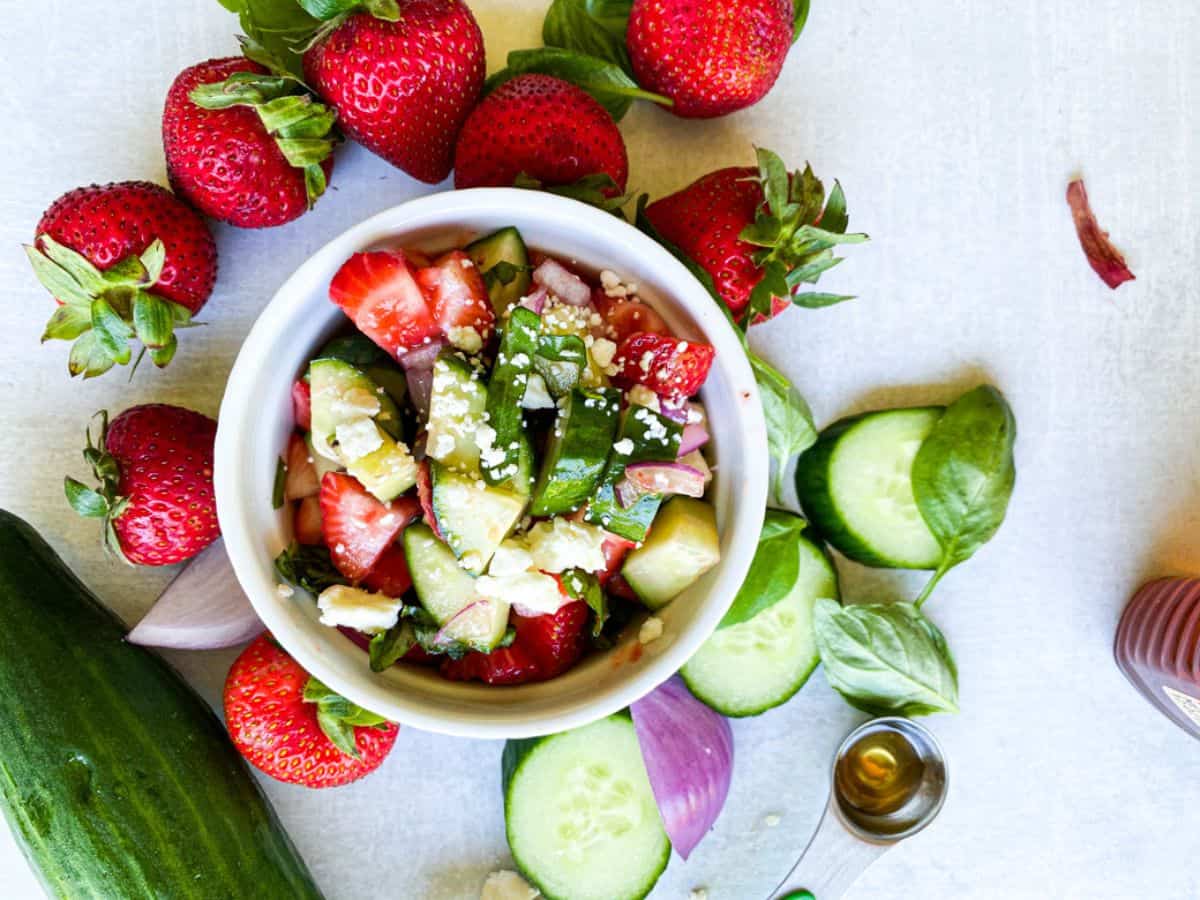 A bowl of cucumber strawberry salad.