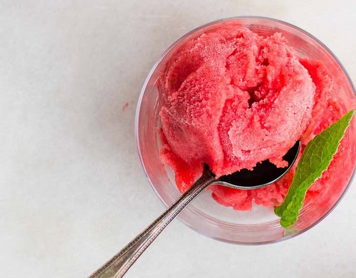 A cup full of strawberry mint sorbet.
