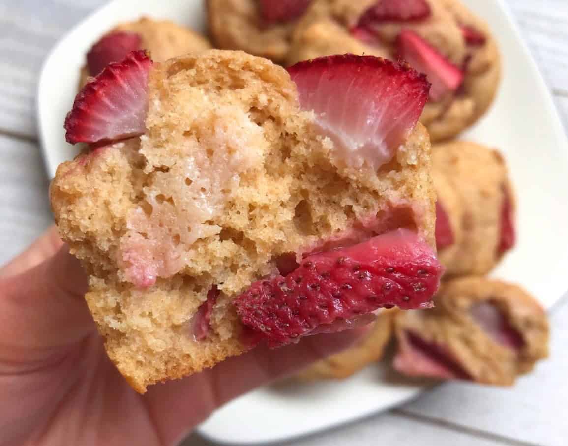 A strawberry ricotta muffin that's been ripped in half.
