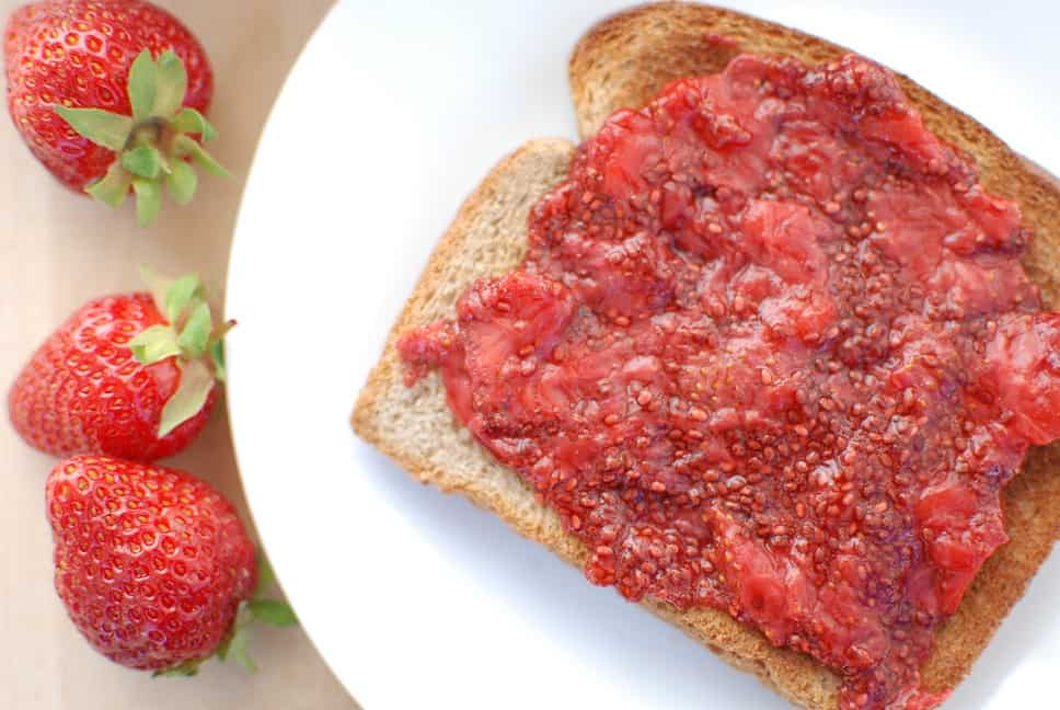 A slice of toast with chia seed jam spread all over it.