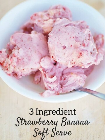 Strawberry banana nice cream in a bowl on a wooden board.