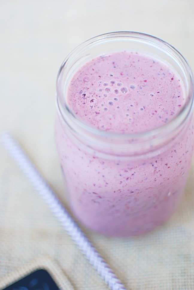 Close up of a chocolate cherry smoothie in a mason jar